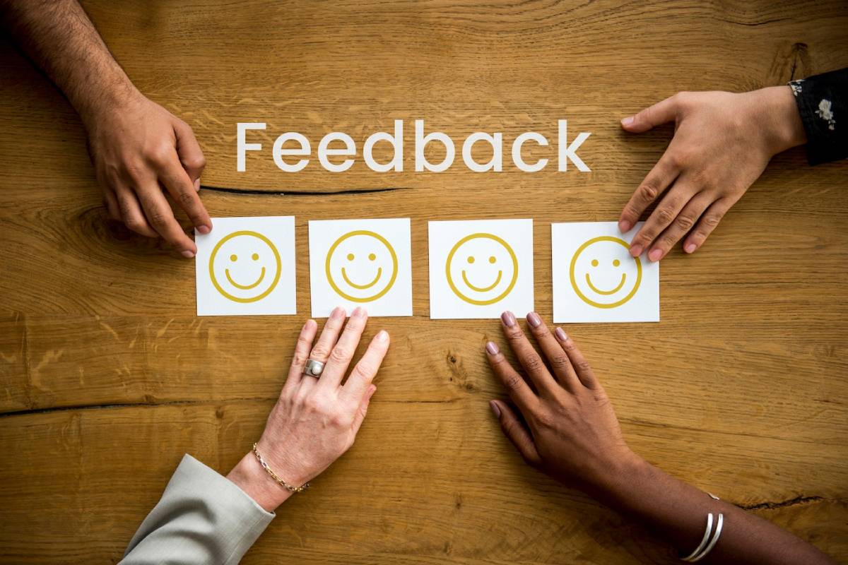 Hands holding a piece of paper displaying written feedback, emphasizing the importance of constructive criticism.