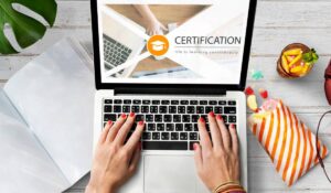 A woman is engaged in typing on a laptop that features a visible certificate, indicating her achievement or qualification.