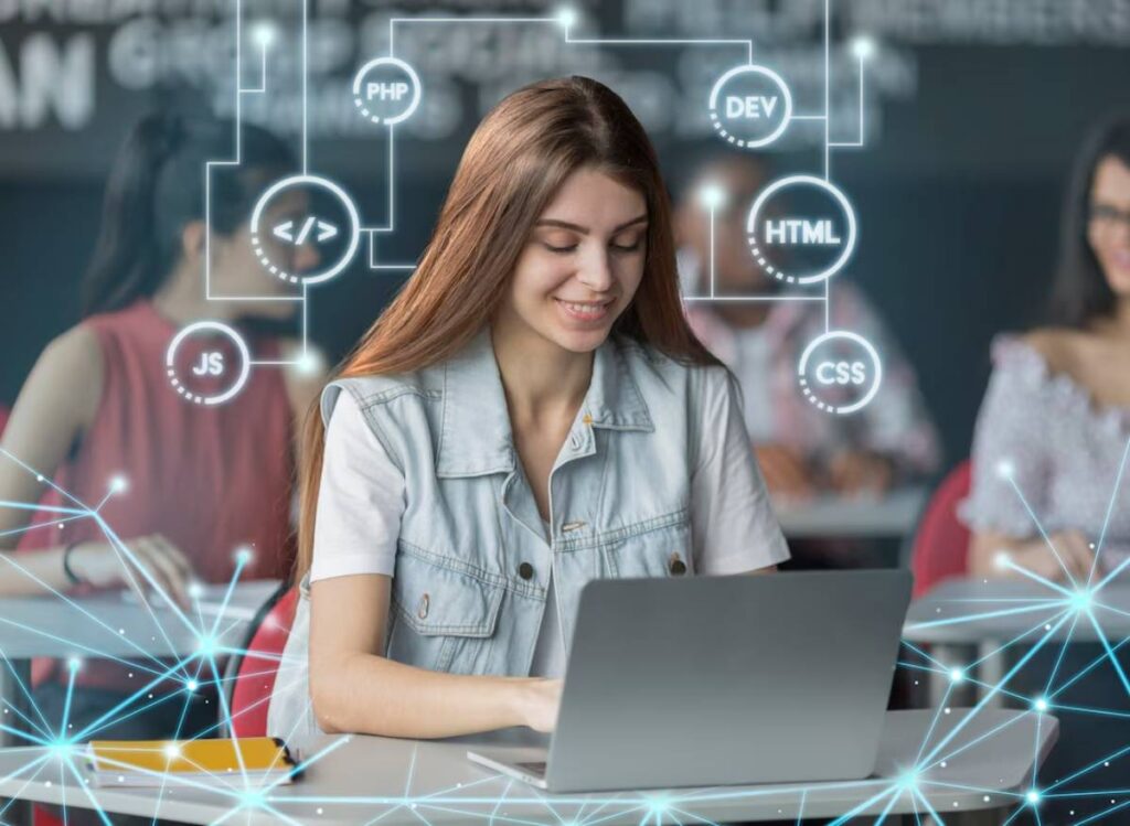 A student in a classroom, focused on a laptop, surrounded by digital icons representing coding languages like PHP, JS, HTML, and CSS.