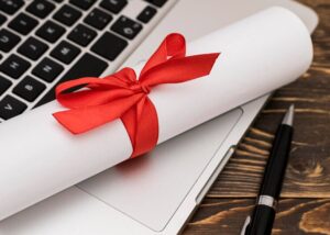 A white roll of paper tied with a red ribbon, elegantly presented for a gift or special occasion.