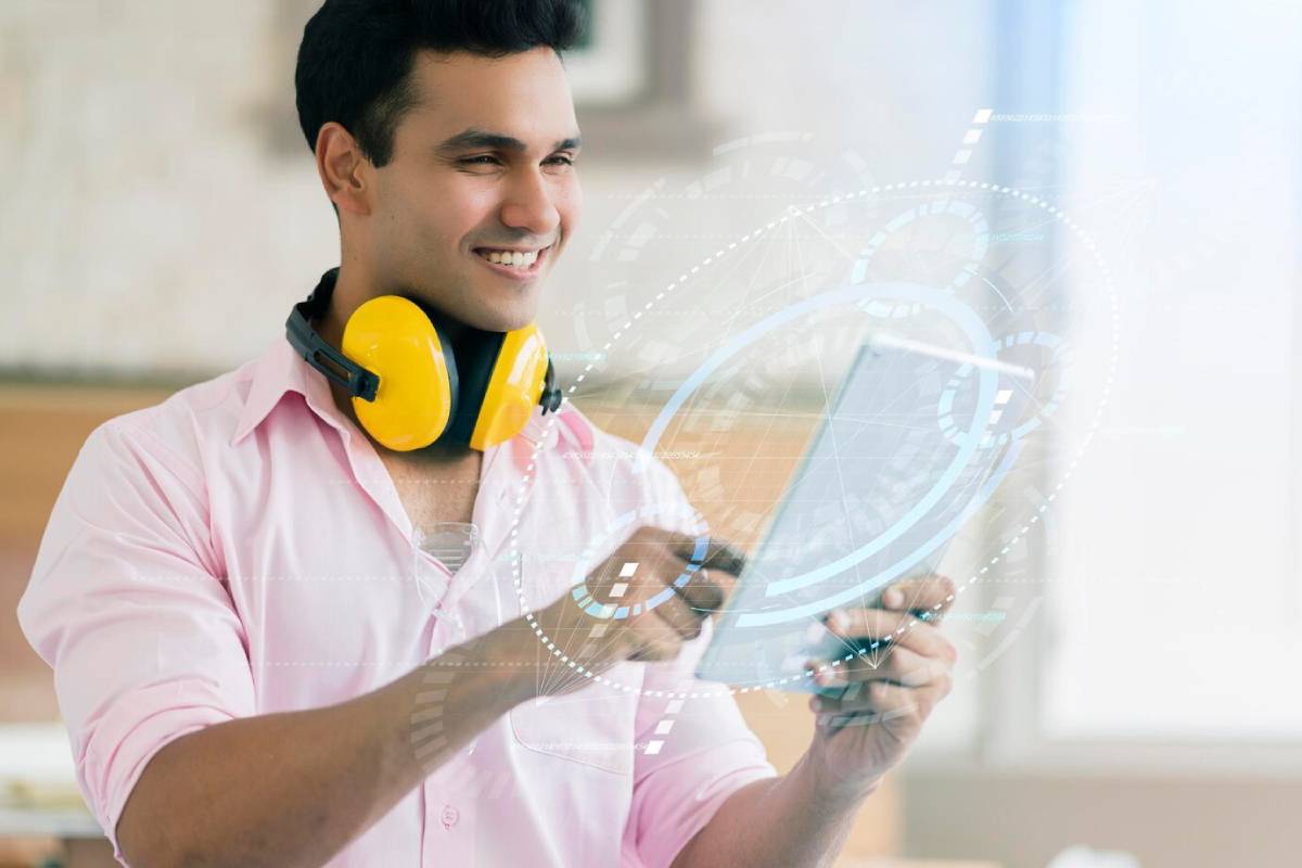A person in a pink shirt and yellow headphones interacts with a digital tablet, surrounded by futuristic graphics. 